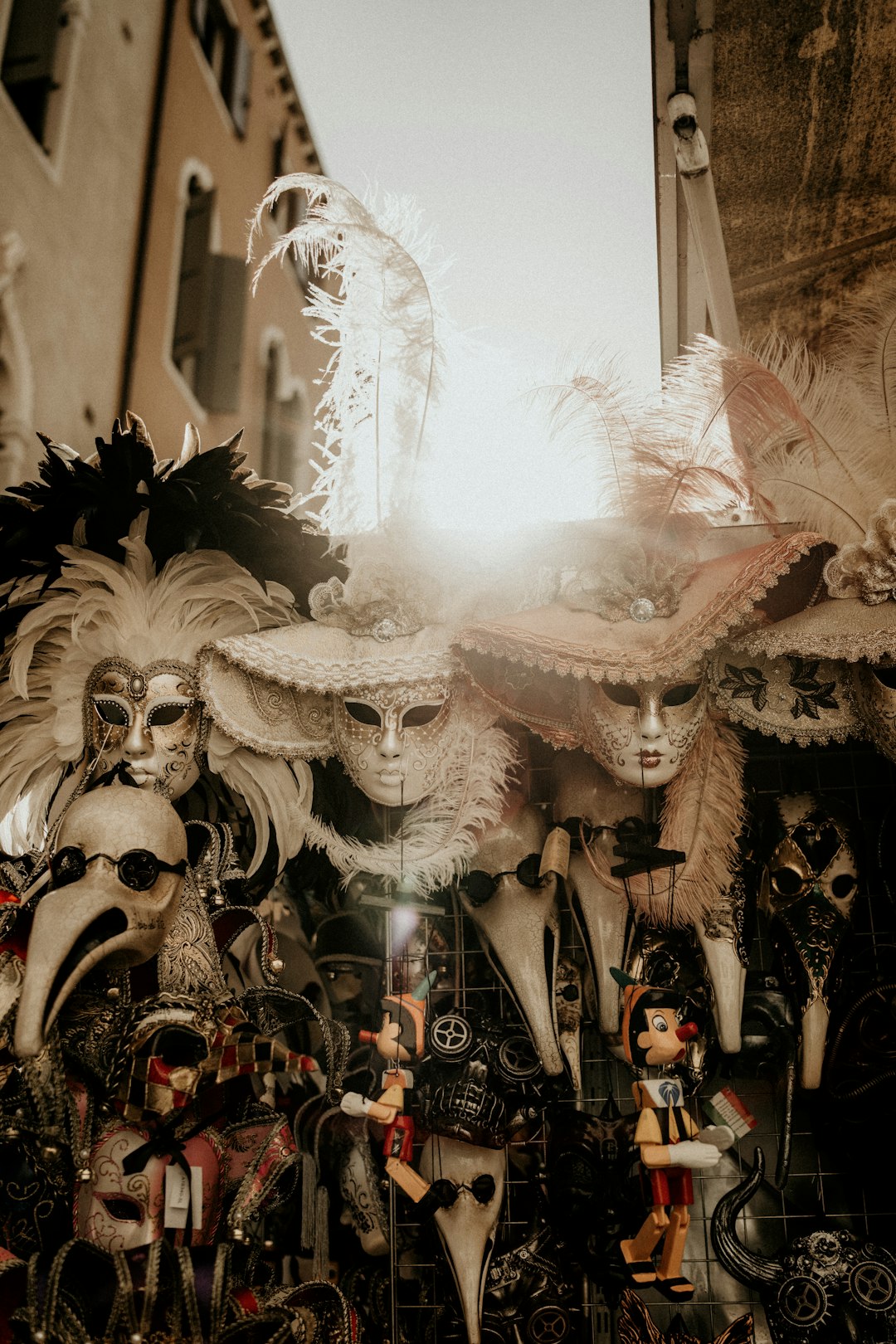 Elaborate Venice Carnival costume and bauta mask against historic Venetian building