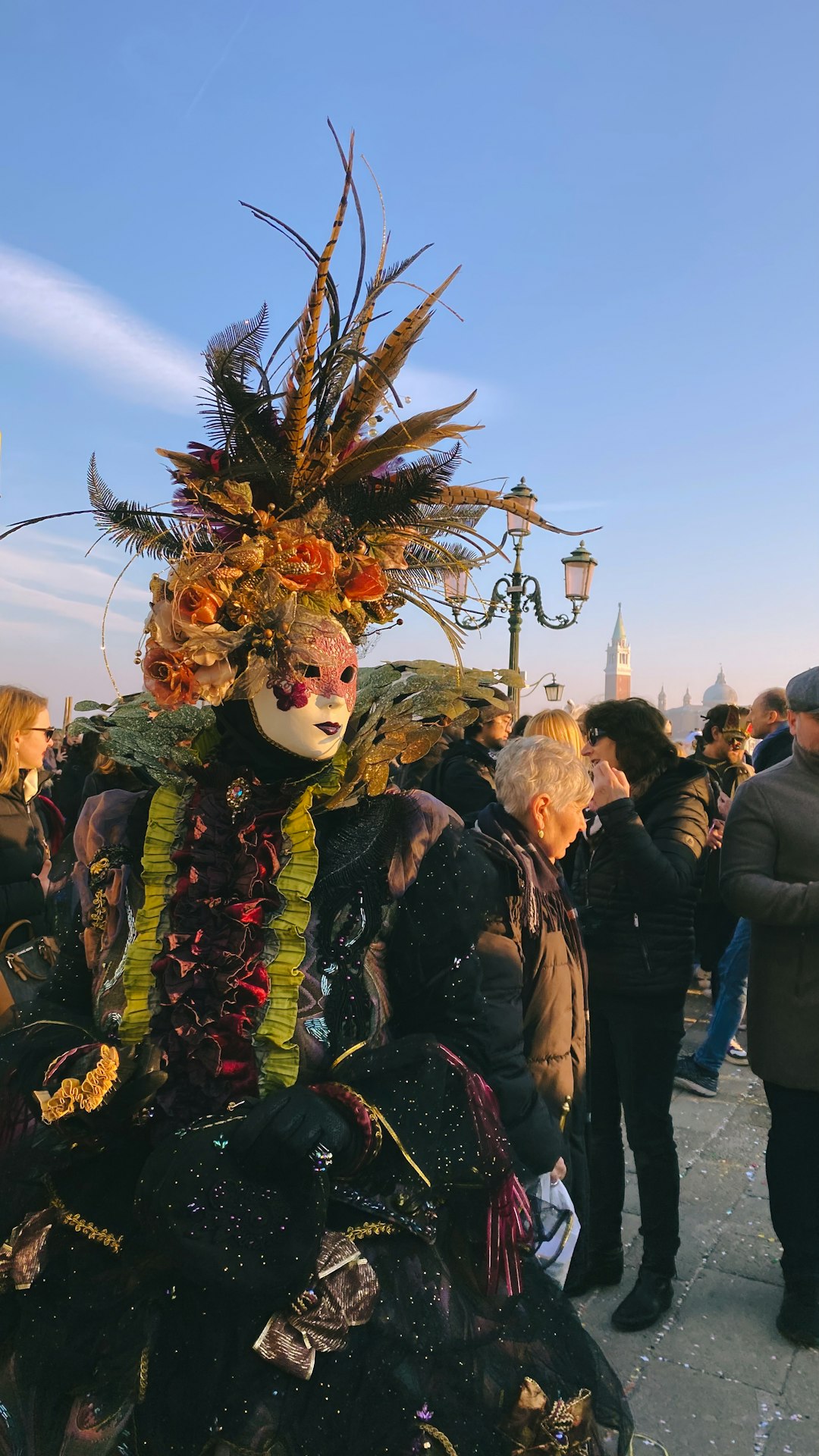 Venice Carnival masks and gondola on canal with ornate historical palazzo