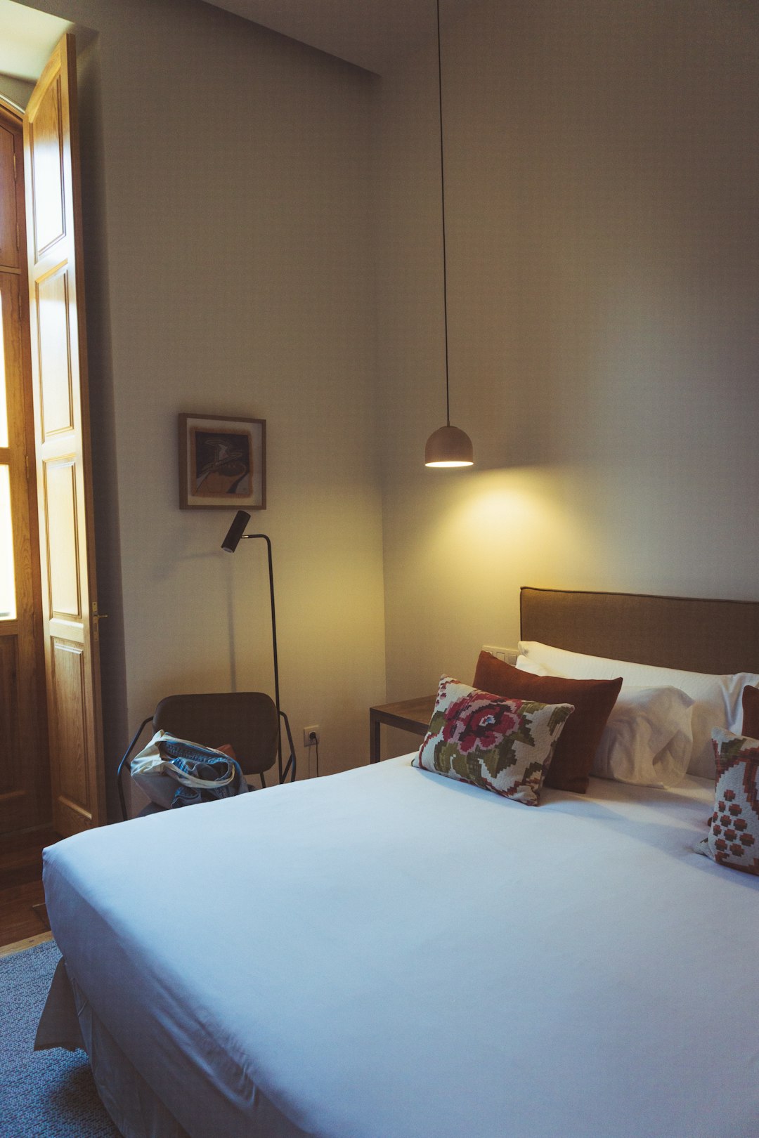Boutique Italian hotel room with terracotta floors historic beams and garden view in Tuscany