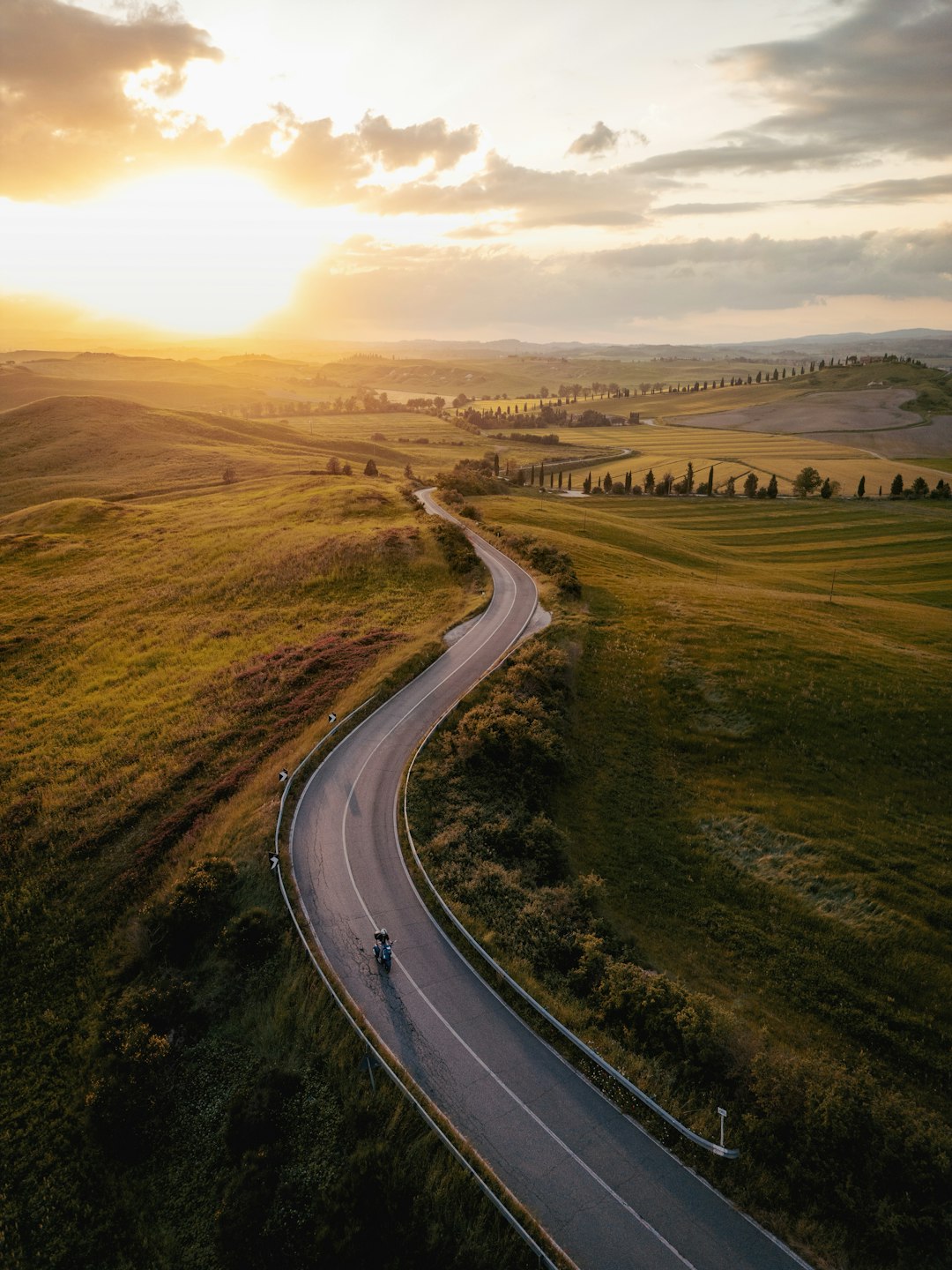 Italian Alps mountain road with Dolomite peaks and hairpin bends in summer landscape