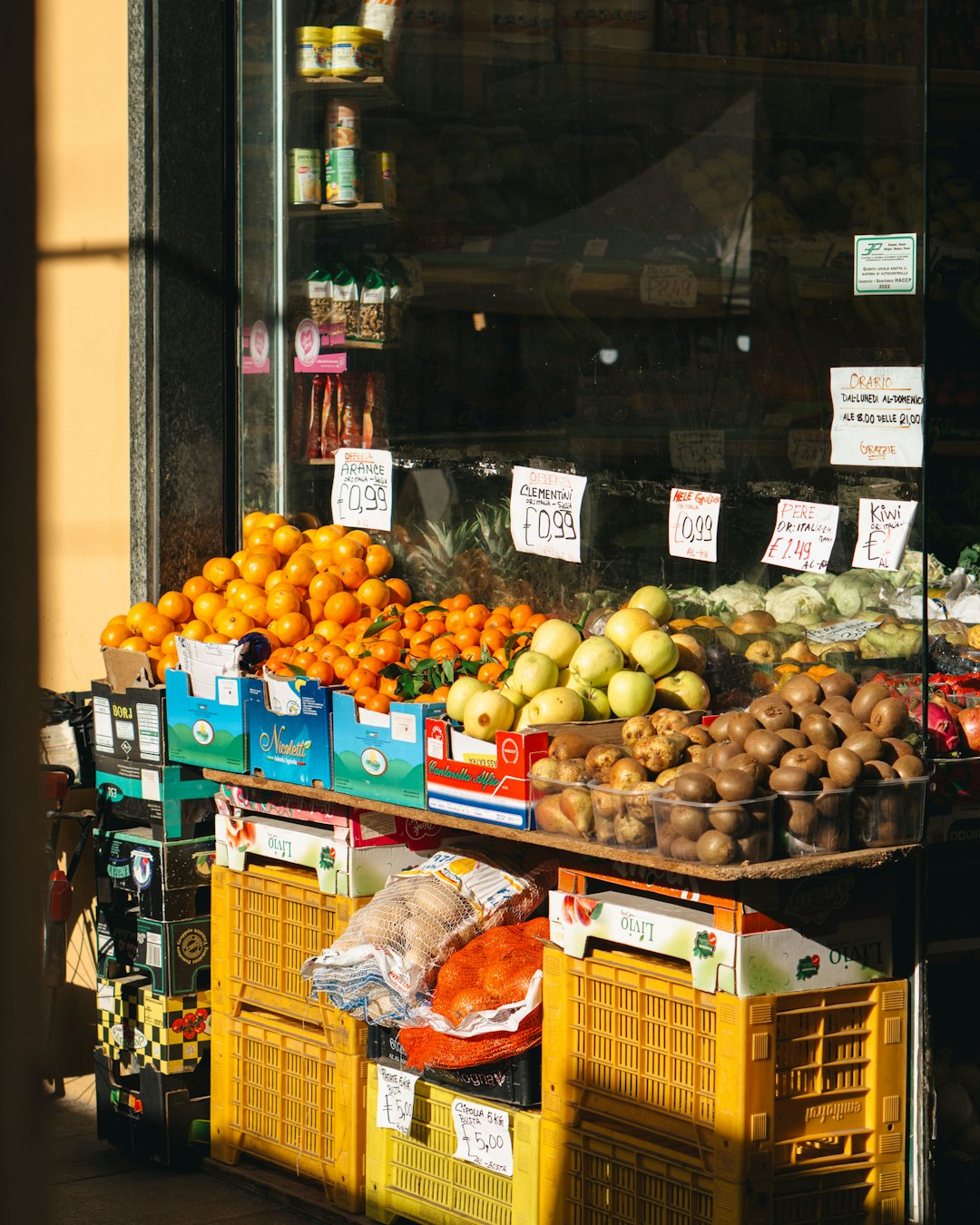 Italian outdoor food market with vegetables fruit cheese and salumi stalls in historic piazza