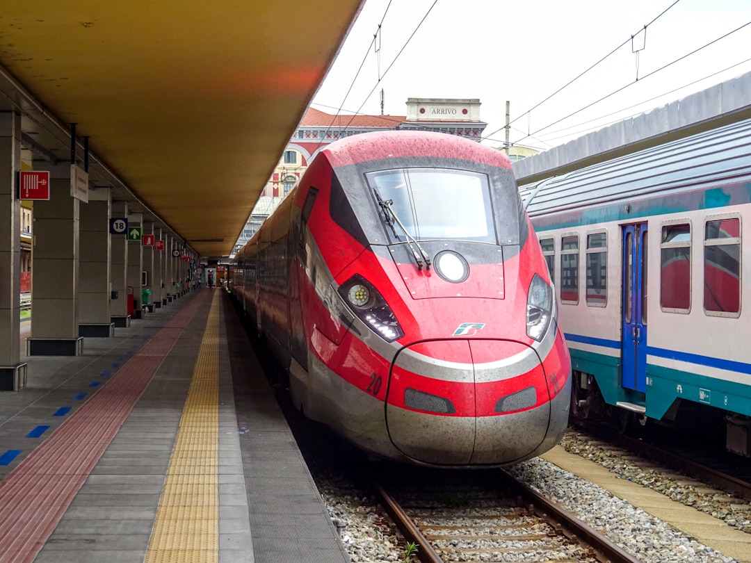 Red Frecciarossa high-speed train at a station platform in Italy