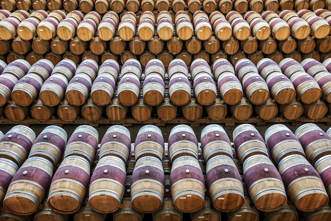 Traditional Emilian cantina interior with wine bottles and wooden barrels